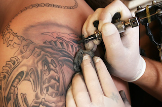 man-receiving-tattoo-with-black-ink