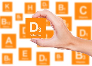 Hand holds a box of vitamin D3
