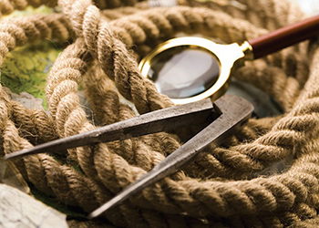 magnifying glass, rope, and compass