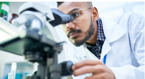 scientist using microscope in laboratory